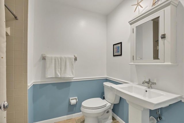 bathroom with tile patterned flooring, curtained shower, and toilet