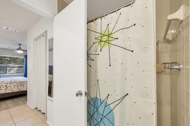 bathroom with tile patterned floors, ceiling fan, and a shower with curtain