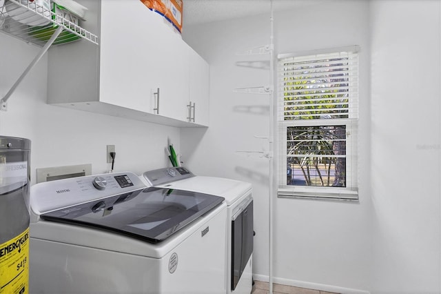 laundry room with cabinets and independent washer and dryer