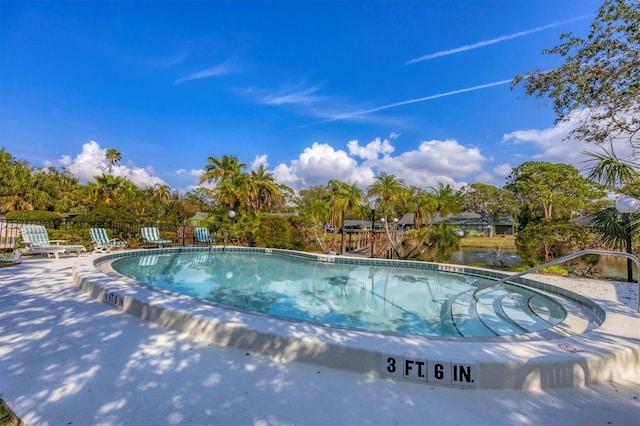 view of swimming pool with a water view