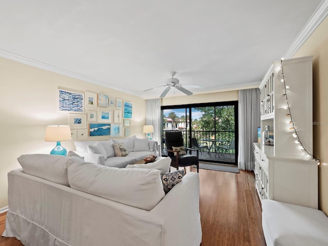 living room with ornamental molding, wood-type flooring, and ceiling fan