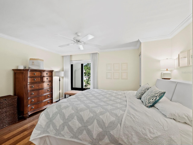 bedroom with dark wood-type flooring, ornamental molding, and ceiling fan