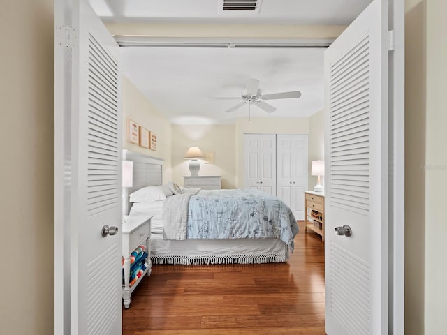 bedroom with ceiling fan and dark hardwood / wood-style flooring