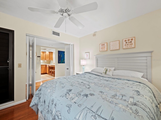 bedroom with hardwood / wood-style flooring, a closet, and ceiling fan