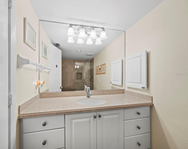 bathroom featuring vanity and tiled shower