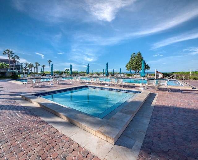 view of swimming pool featuring a patio area