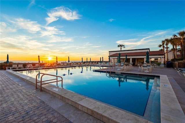 pool at dusk with a water view