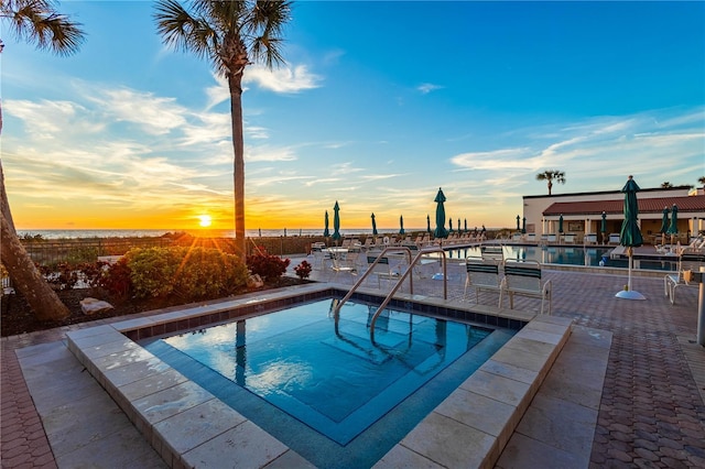 pool at dusk with a water view