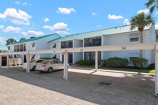 view of building exterior featuring covered parking