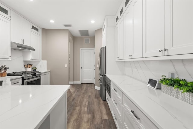 kitchen with visible vents, appliances with stainless steel finishes, light stone countertops, under cabinet range hood, and white cabinetry