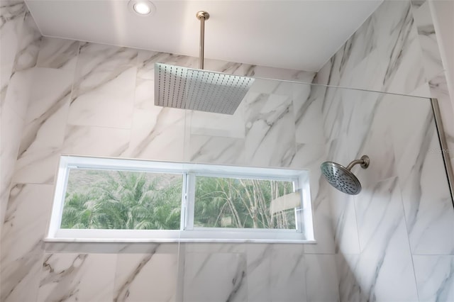 interior details featuring a marble finish shower