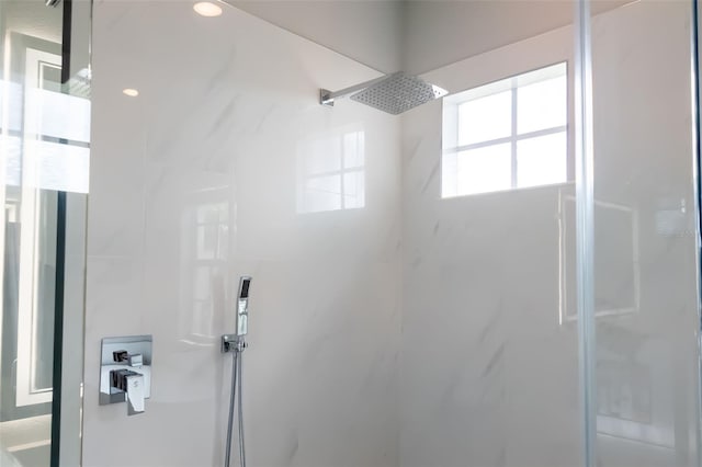 full bathroom with a marble finish shower