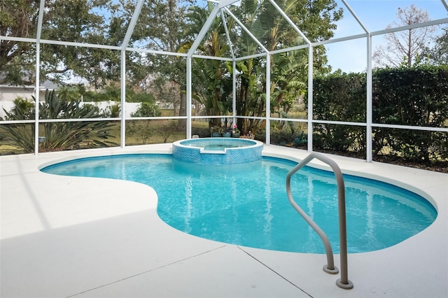 view of pool featuring a lanai, a pool with connected hot tub, and a patio