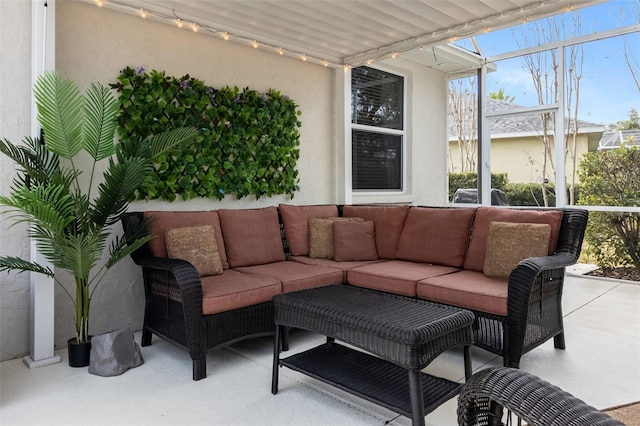 view of patio featuring glass enclosure and an outdoor hangout area