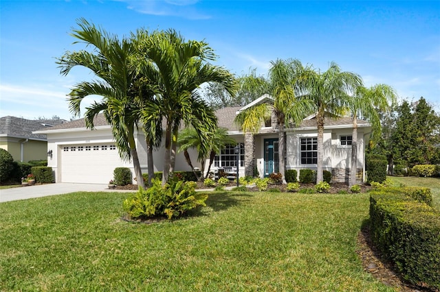 single story home with a garage, concrete driveway, a front yard, and stucco siding