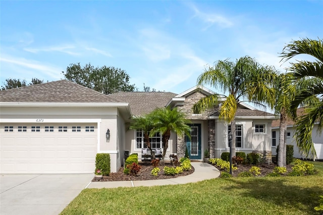 single story home featuring stucco siding, a shingled roof, a front yard, a garage, and driveway