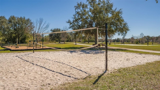 surrounding community with a yard and volleyball court