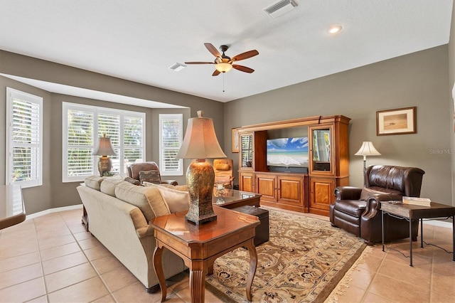 living room with ceiling fan and light tile patterned flooring