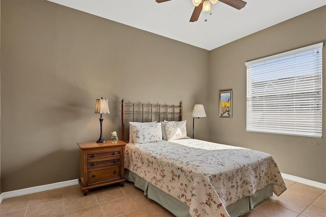 tiled bedroom featuring ceiling fan