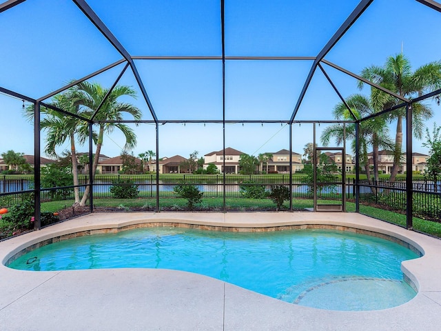 view of pool featuring a fenced in pool, a residential view, a lanai, and fence