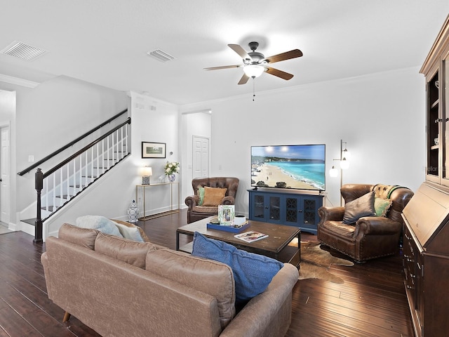 living area with crown molding, stairway, visible vents, and hardwood / wood-style flooring