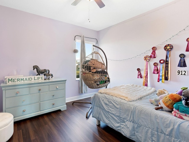 bedroom featuring a ceiling fan, baseboards, and wood finished floors