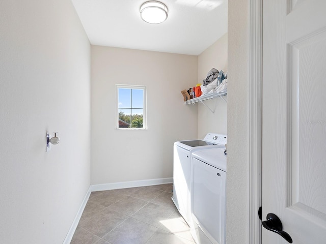 washroom with washer and dryer, laundry area, baseboards, and light tile patterned floors