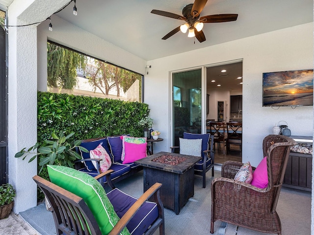 view of patio with an outdoor living space with a fire pit and ceiling fan