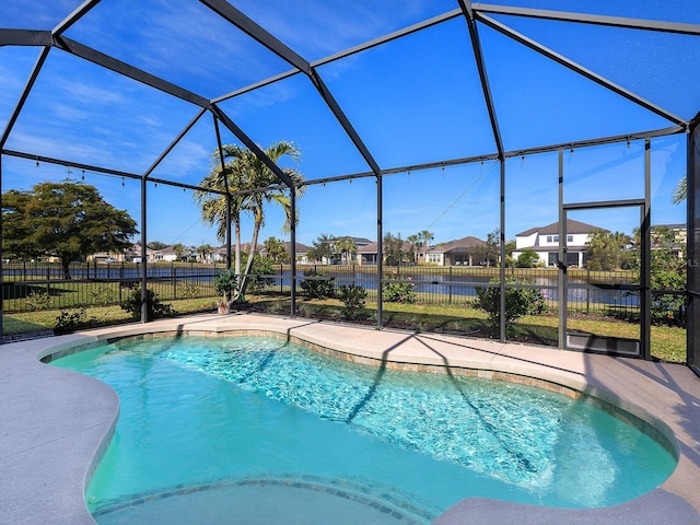 view of pool featuring a fenced in pool, a residential view, glass enclosure, and fence