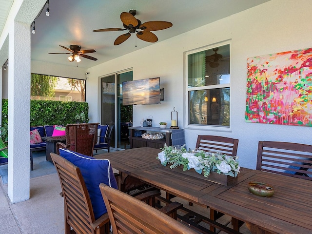 view of patio featuring outdoor dining area and a ceiling fan