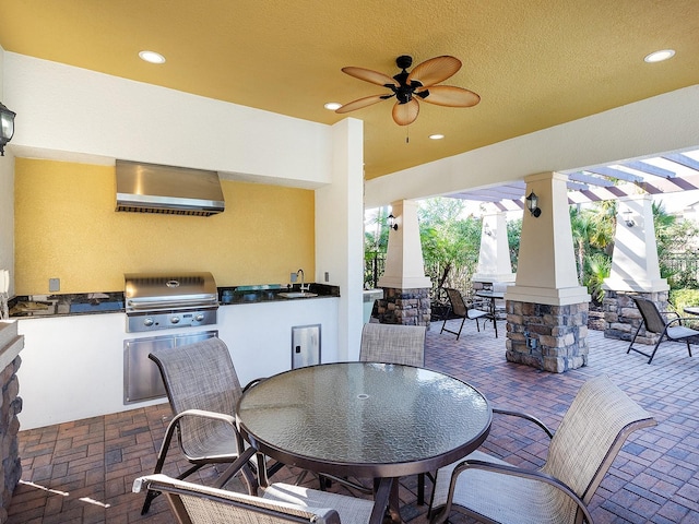 view of patio / terrace with outdoor dining area, area for grilling, a sink, a grill, and ceiling fan