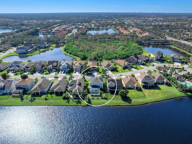 drone / aerial view featuring a residential view and a water view