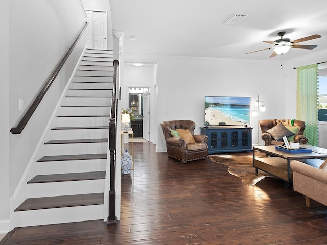 living room featuring stairway, ceiling fan, visible vents, and hardwood / wood-style floors