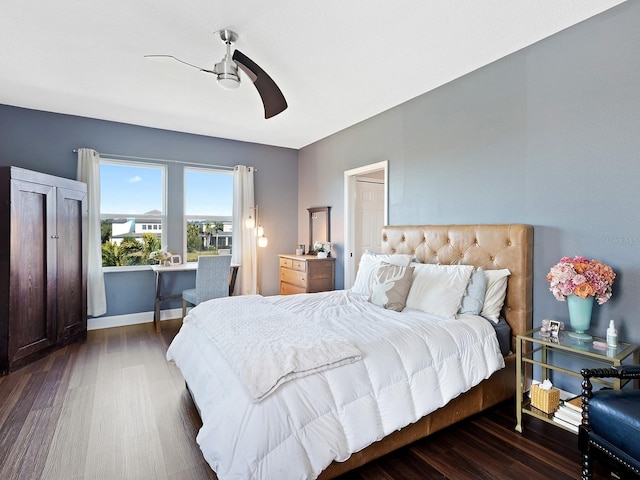 bedroom featuring wood finished floors, a ceiling fan, and baseboards