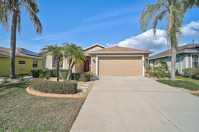 single story home with a garage and a front lawn