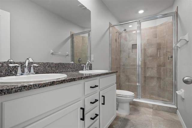 bathroom with vanity, toilet, and a shower with shower door