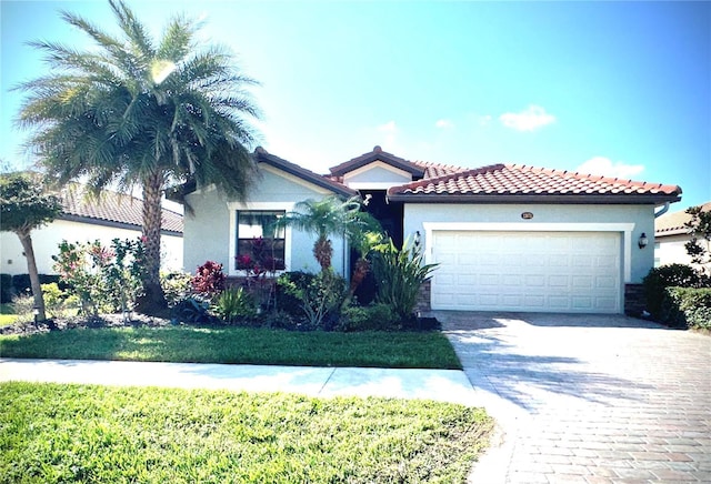 mediterranean / spanish-style house featuring a garage and a front yard