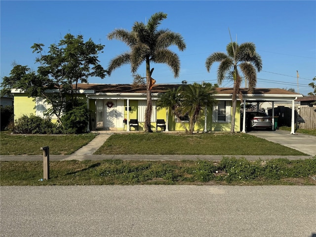 view of front of property featuring a carport and a front lawn