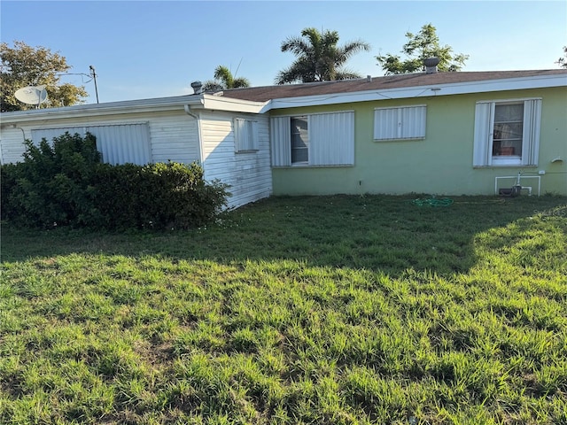 view of property exterior with a yard