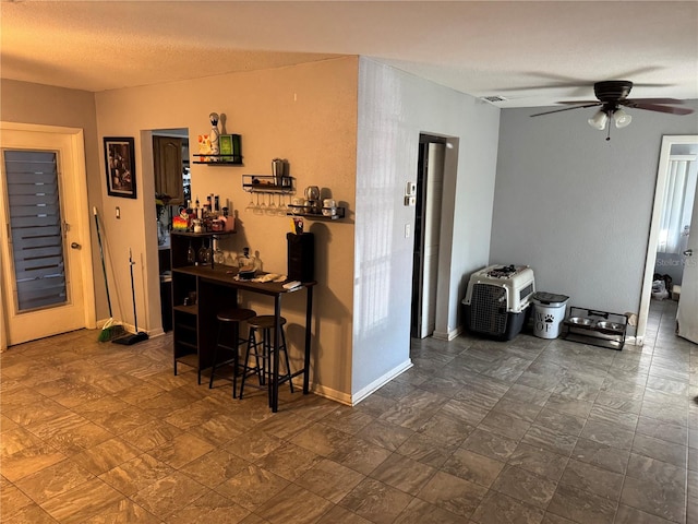 interior space featuring a textured ceiling and ceiling fan