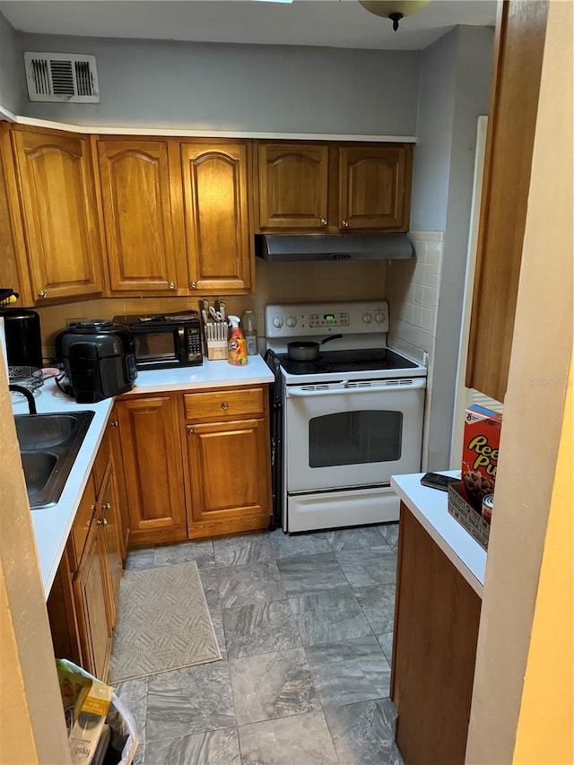 kitchen with tasteful backsplash, sink, and white electric stove