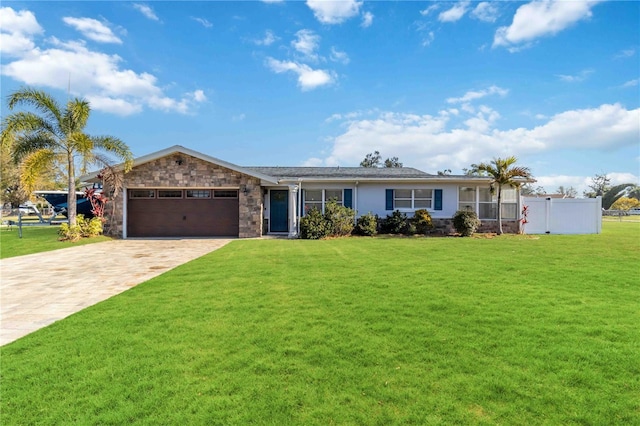 ranch-style house with a garage and a front yard