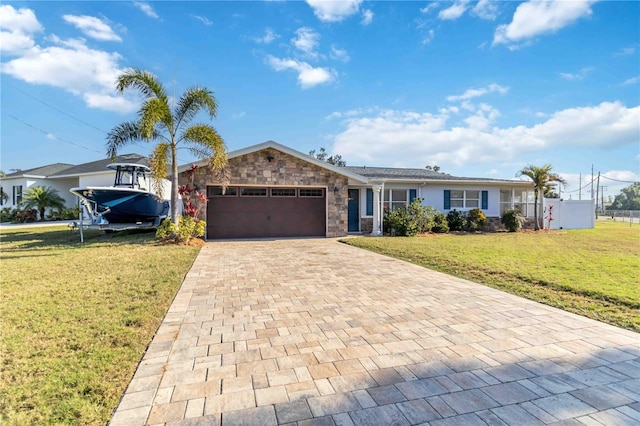 ranch-style house featuring a garage and a front yard