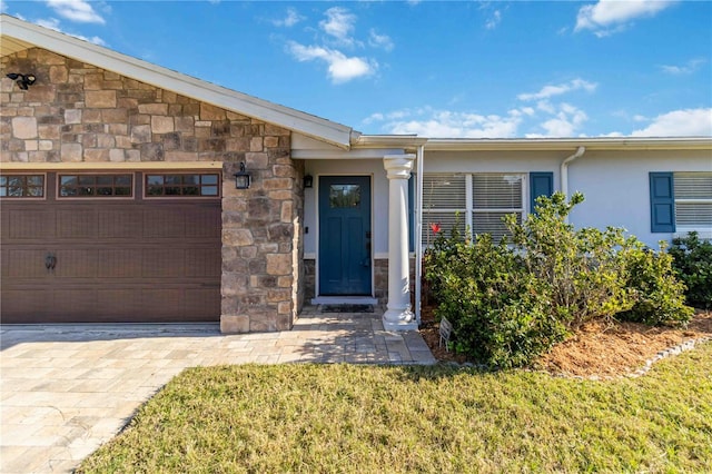 view of front of property with a garage and a front lawn