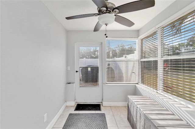 interior space with ceiling fan and light tile patterned flooring