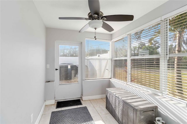 sunroom / solarium featuring ceiling fan