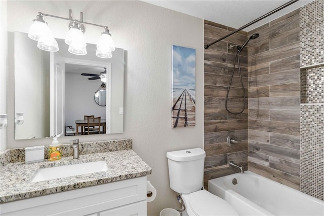 full bathroom featuring vanity, ceiling fan, tiled shower / bath combo, and toilet