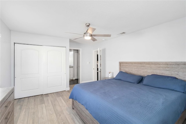 bedroom featuring light hardwood / wood-style floors, a closet, and ceiling fan