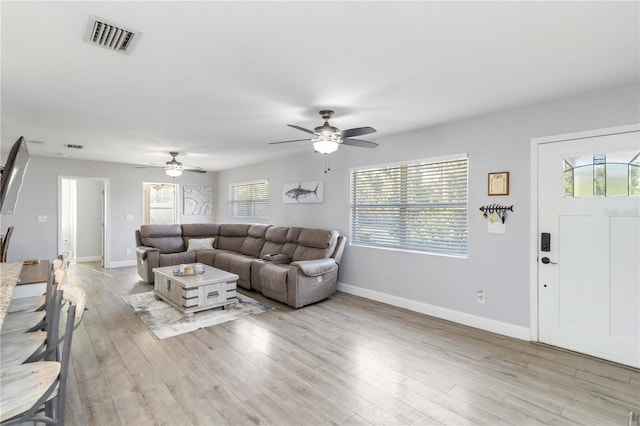 living room with ceiling fan and light wood-type flooring