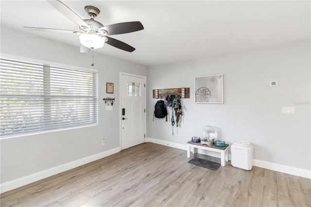 foyer entrance with light hardwood / wood-style flooring and ceiling fan